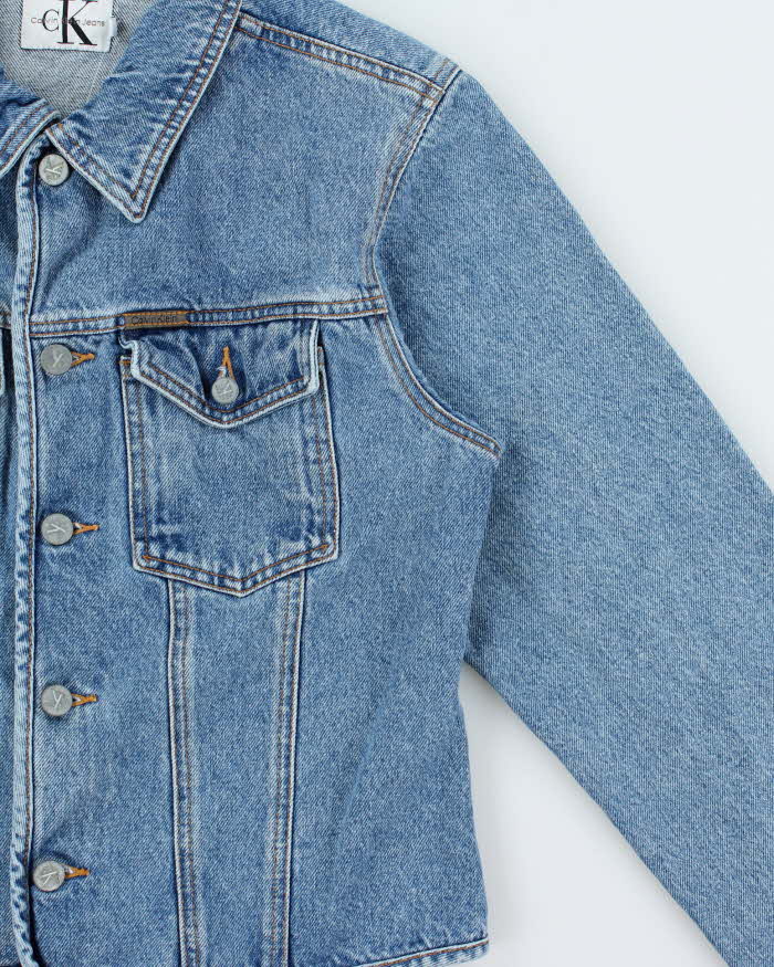 Vintage 1990s Calvin Klein Women's Medium Wash Cropped Denim Jacket - L