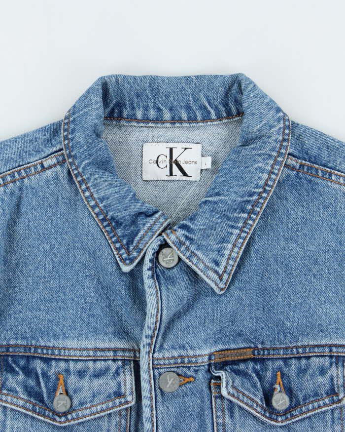 Vintage 1990s Calvin Klein Women's Medium Wash Cropped Denim Jacket - L