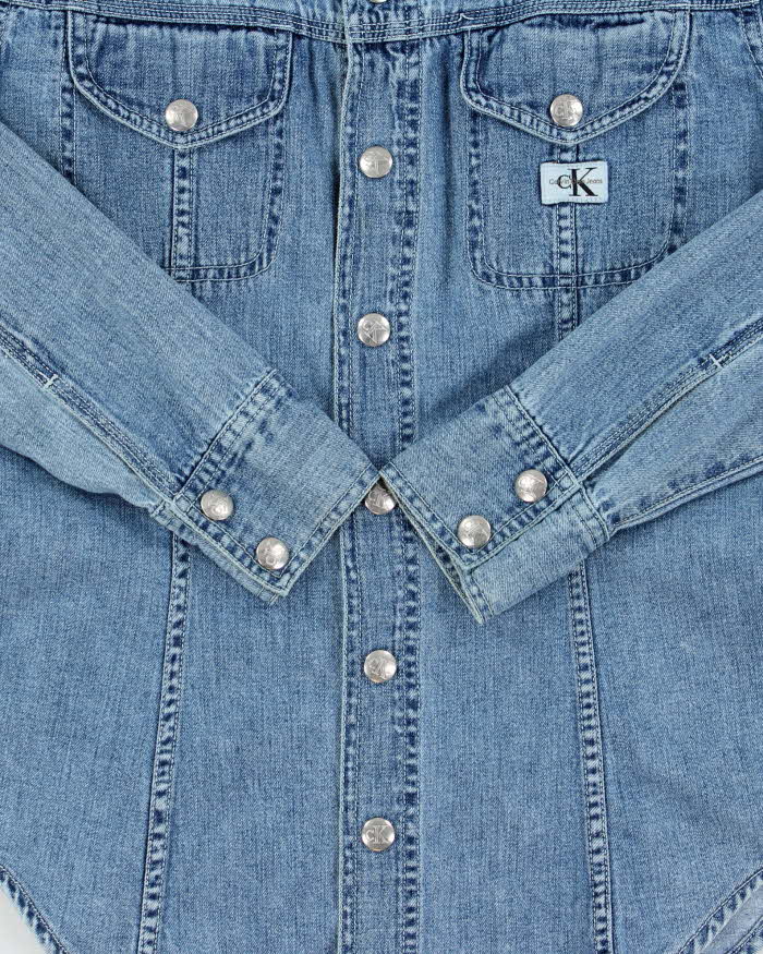 Vintage 1990s Calvin Klein Women's Light Wash Denim Snap Button Long Sleeve Shirt - S